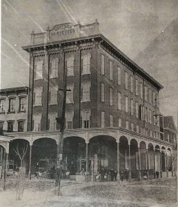 old photo of the red building at 4th and state street that used to be confers varieties