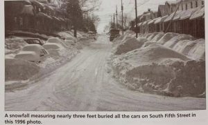 feet of snow piled high along houses on south fifth street