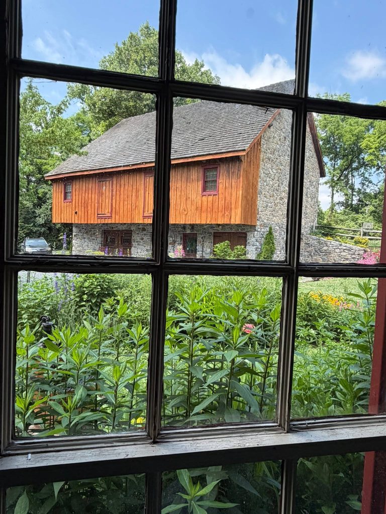 view of the rebuilt homestead barn from inside the house
