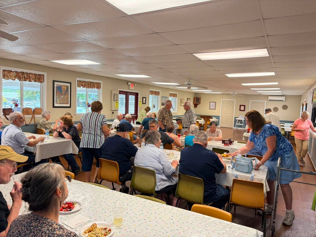 members gathering and socializing at the annual picnic 2026
