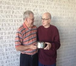 Domer Leibensperger passing on the King Frost crown to George Mitten